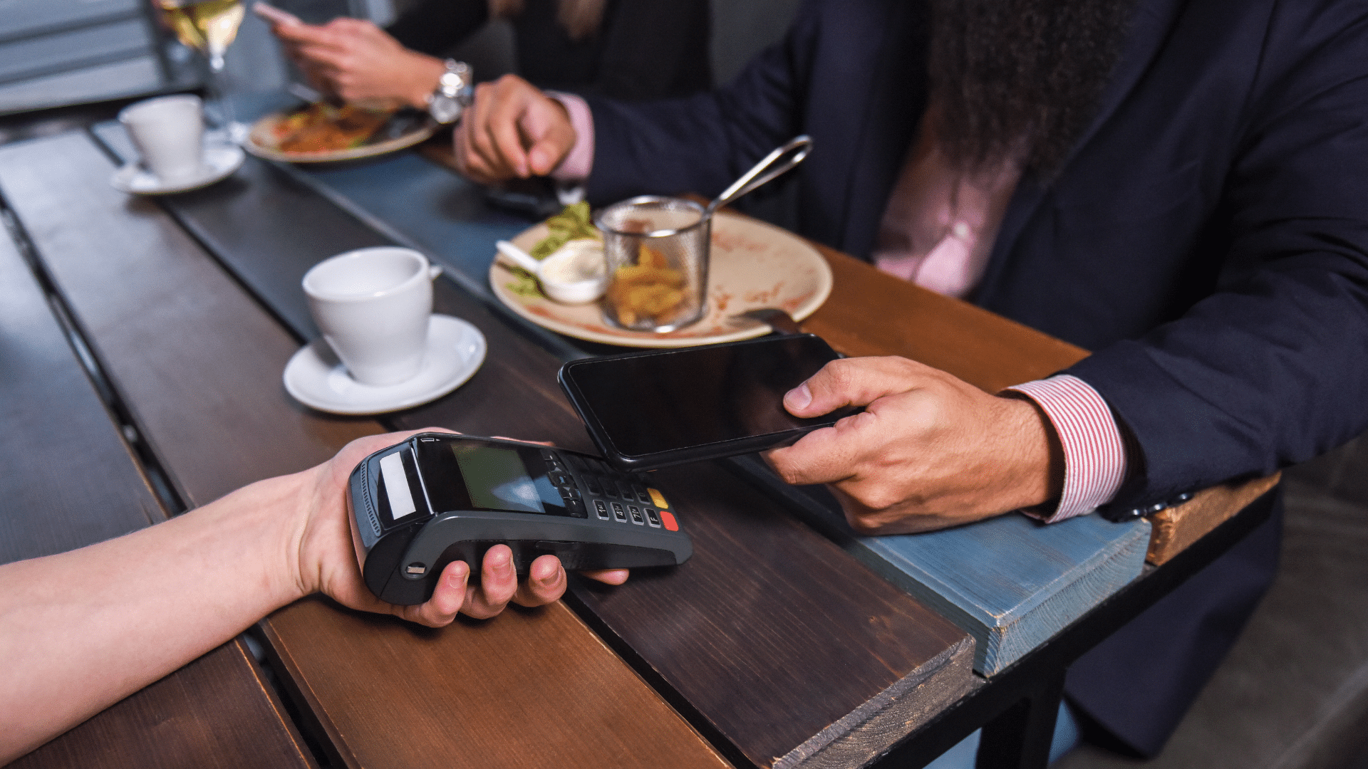 An image of a London Ontario small business owner paying for a corporate lunch with his cell phone