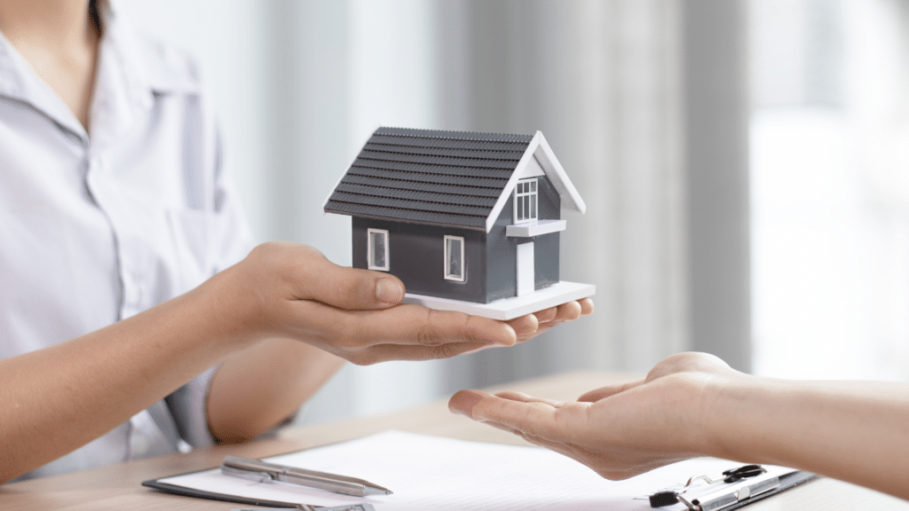 An image of a person holding a face house in her hand