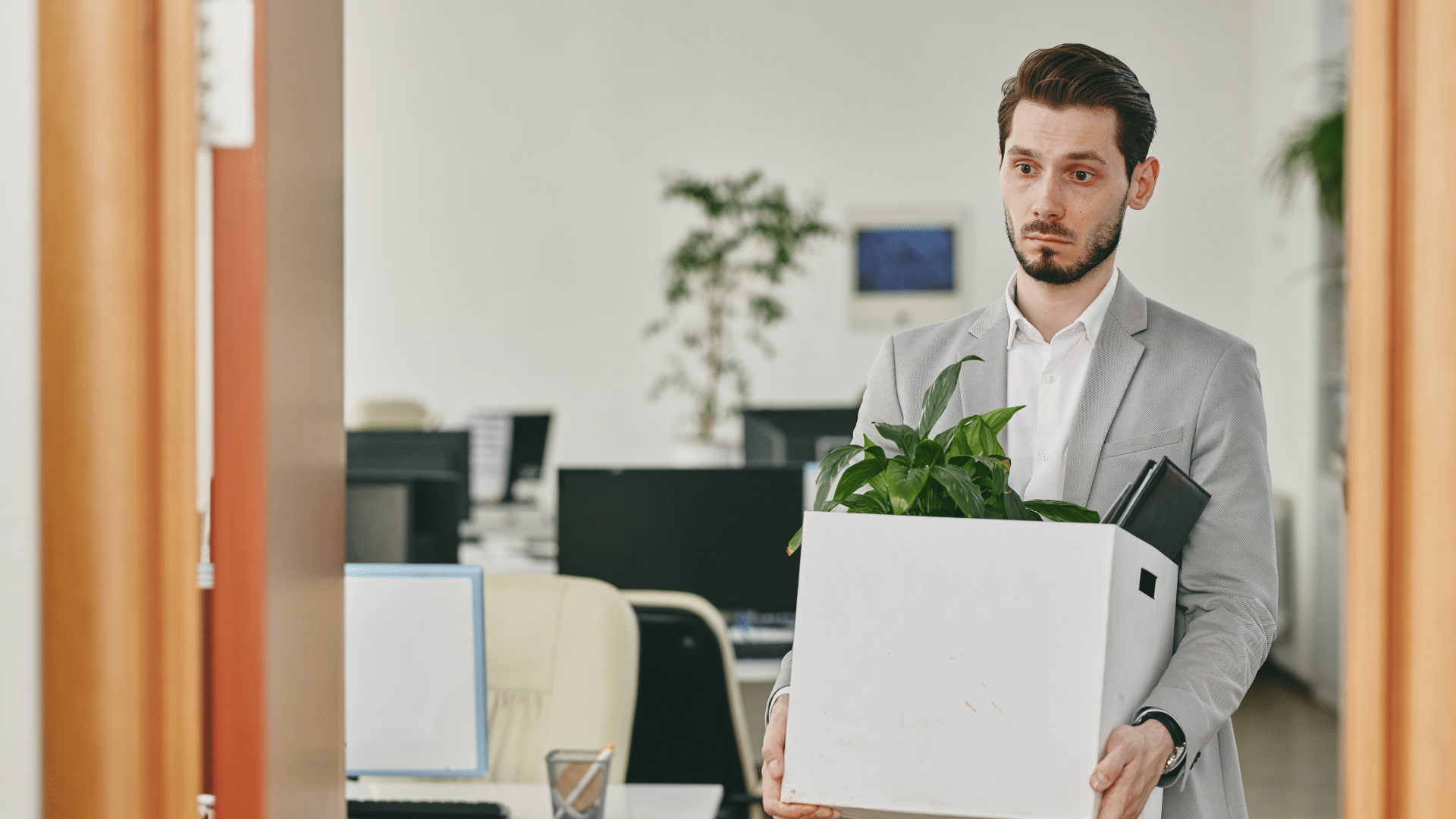 An image of an employee who was recently let go from his position at work with his possessions.